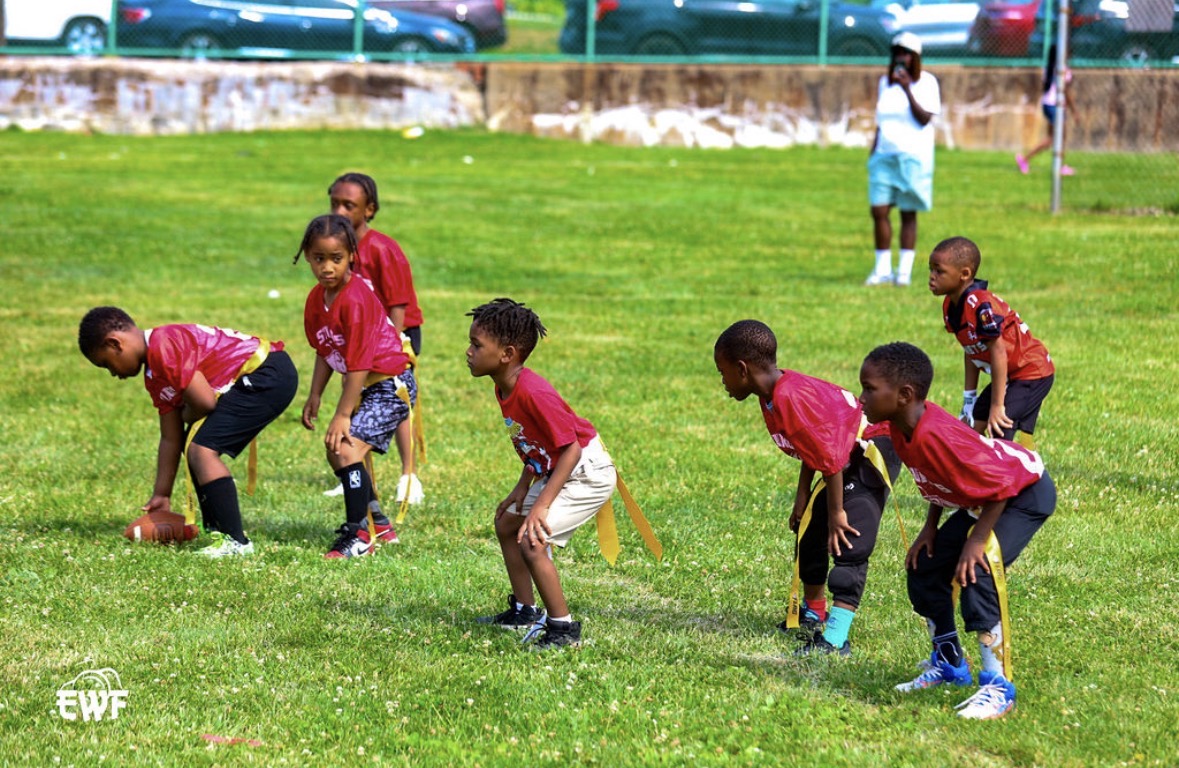 Flag football game action - kids at line of scrimmage