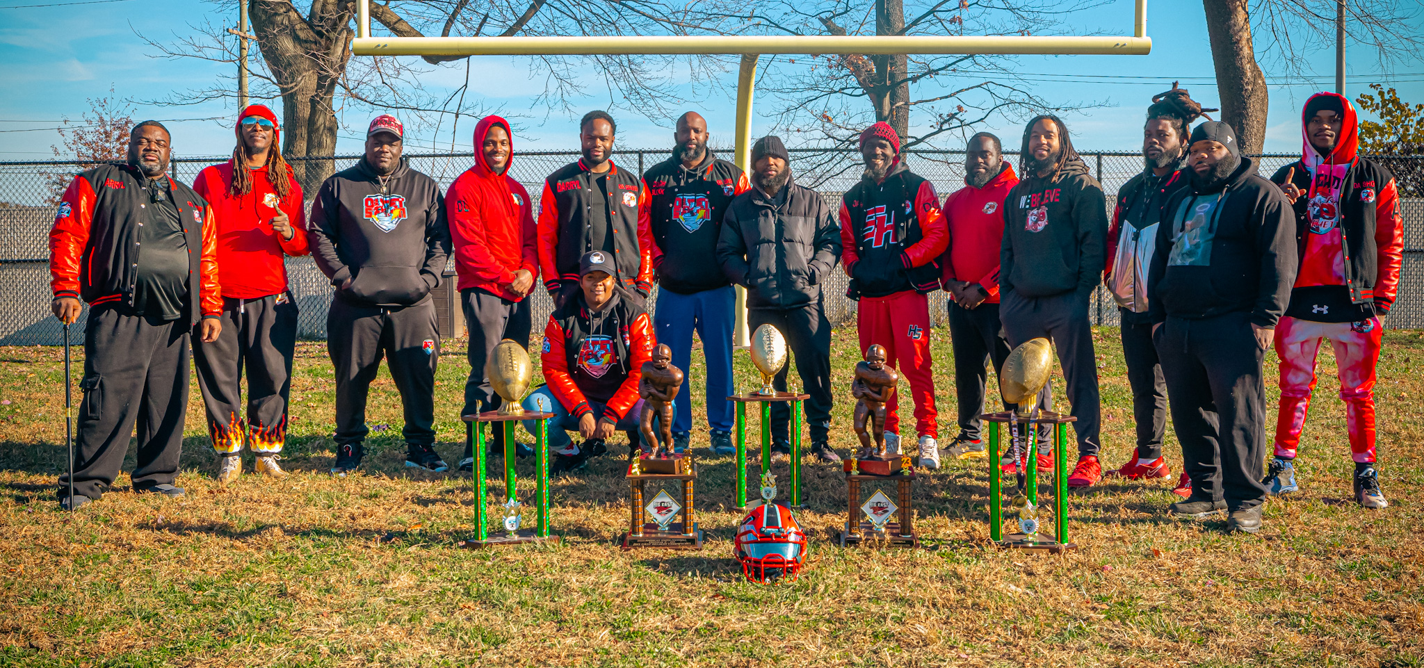 Coaching staff with championship trophies